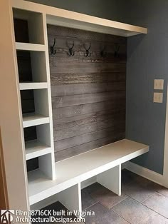 a room with a bench and shelves in it