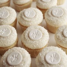 cupcakes with white frosting and monogrammed icing