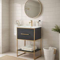 a bathroom with a sink, mirror and toilet paper holder on the floor in front of it