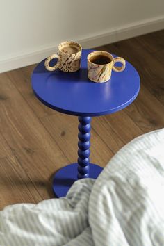 a blue table with two cups on it