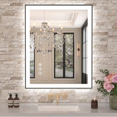 a bathroom with a sink, mirror and chandelier