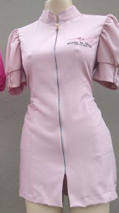 a mannequin wearing a pink dress with white zippers