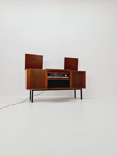 an old radio sitting on top of a wooden cabinet