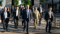 men in suits and ties walking down the street