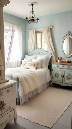 a bedroom with blue walls and white furniture