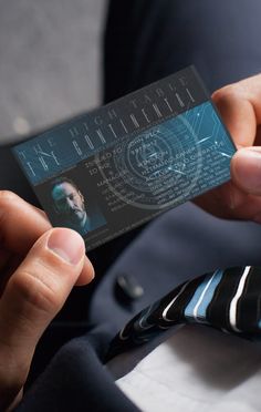 a person holding up a business card in their left hand with the words the continental on it