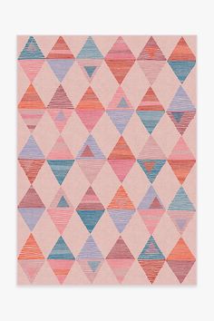 a pink rug with blue, red and orange triangles on it