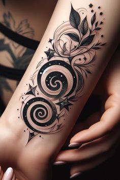 a woman's arm with an artistic tattoo design on her left forearm and wrist