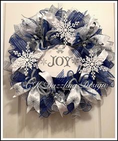 a blue and white christmas wreath with snowflakes