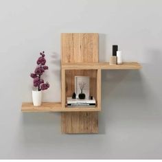 two wooden shelves with vases and books on them