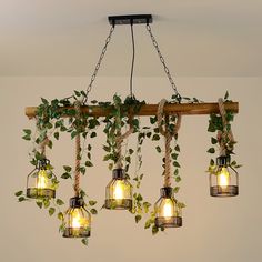 a bunch of light bulbs hanging from a wooden beam with ivy growing in them and some lights on the ceiling