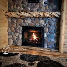 a stone fireplace in a log cabin