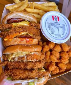 chicken sandwich with fries and ketchup in a box on the table next to it