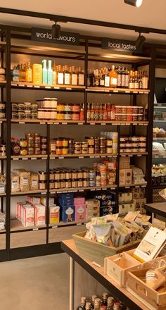 the inside of a grocery store with shelves full of food and condiments on display