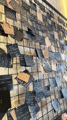 a wall covered in lots of different types of writing on it's sides and notes attached to the walls