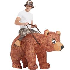 a man riding on the back of a brown bear