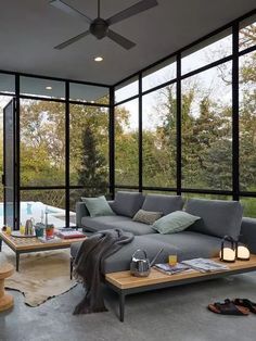 a living room filled with furniture and lots of windows