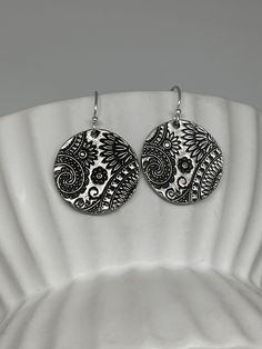 These beautiful silver round paisley floral earrings have been handmade using .950 sterling silver. They have been cut from sterling silver precious metal clay, textured, fired and oxidized. The earrings hang from sterling silver ear wires. From the Paisley Mod Collection, these sterling silver earrings are lightweight for wearing and feature a beautiful engraved floral paisley textured pattern. A great everyday pair of earrings that can be worn time and time again. These earrings measure about Sterling Silver Flower Earrings, Silver Flower Earrings, Precious Metal Clay, Paisley Floral, Sterling Silver Flowers, Metal Clay, Modern Bohemian, Etsy Earrings Dangle, Precious Metal