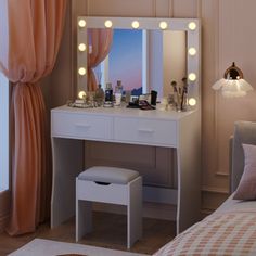 a white vanity with lights on it in a bedroom