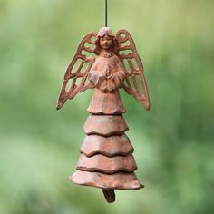 an angel ornament hanging from a wire