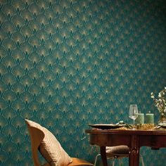 a dining room with a table and chairs next to a wall that has a pattern on it