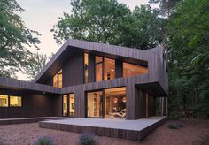 a modern house in the woods at dusk