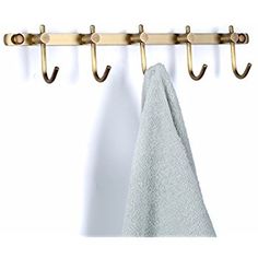 a towel hanging on a coat rack with hooks