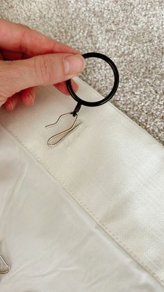 a person is holding some scissors in front of a piece of fabric that has been sewn together