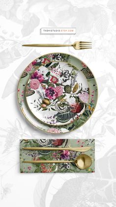 an image of a table setting with flowers and gold cutlers on the plate, fork and knife