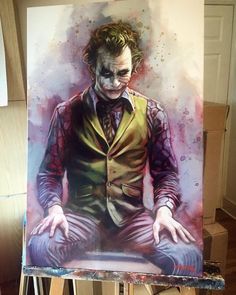 a painting of the joker sitting on top of a easel with his hands in his pockets