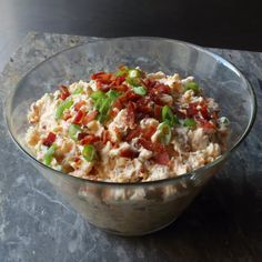 a glass bowl filled with food on top of a table