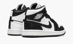 The Women’s Air Jordan 1 Mid “Split Black and White” is a women’s-exclusive colorway with a mismatched design.  As its name implies, the “Split Black and White” Jordan 1 Mid features a split appearance that inverses the shoe’s black-and-white color block on each side.  The lateral side of the shoe features a white tumbled leather base with contrasting black leather overlays and Swoosh branding.  The medial side reverses the color block, with a black leather base with white leather overlays and S Ying Yang Jordan 1, Womens Black And White Jordans, Jordan 1 Mid Split, Womens Air Jordan 1, Black And White Jordans, Womens Air Jordan, Latest Jordans, Jordan 1 Outfit, Black White Shoes