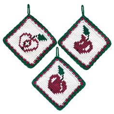 cross stitched christmas ornaments with apples and cherries hanging from the front, set of three