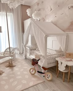 a child's bedroom decorated in pink and white with a canopy over the bed