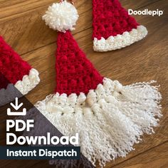 two crocheted santa hats sitting on top of a wooden floor