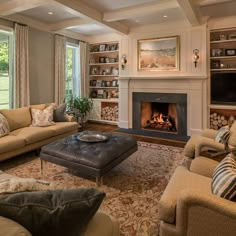 a living room filled with furniture and a fire place in the middle of a room