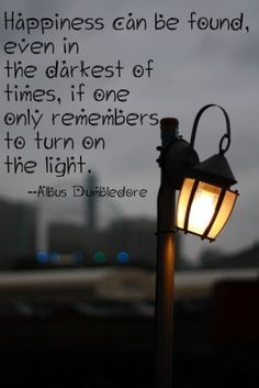 a light post with a quote about happiness