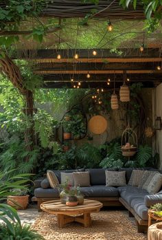 an outdoor living area with couches, tables and potted plants