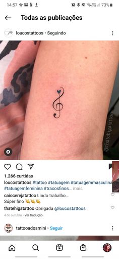 a person with a tattoo on their arm that reads todayas publicaces, and there is an image of a treble