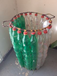 several empty plastic bottles are stacked on top of each other in a room with white walls