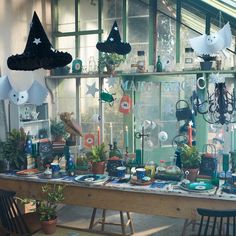 a table covered in lots of plants and decorations