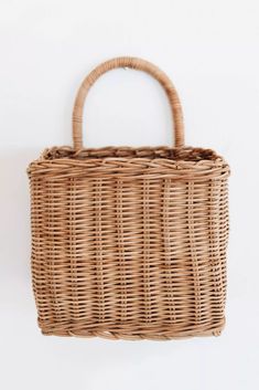 a wicker basket hanging on the wall