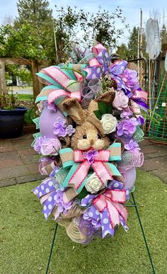 Purple flowers surrounding a adorable burlap bunny. Spring is in the air for sure with this beautiful swag. Handmade with thoughtful care. Display ideas: *Front door ( not for a  storm door) * Living room wall  * Bedroom door * Front Entrance way Measurements: 24" in Length  14" Width  8" depth  Materials: * Styrofoam  * Tear drop greenery  * Mesh  Care instructions:   Tips on keeping your wreath looking it's best for years to come. If hanging outdoors, consider hanging where there is a cover ov Burlap Bunny, Easter Swags, Valentine Door Decorations, Purple Bunny, Door Living Room, Purple Door, Easter Egg Basket, Entrance Way, Lavender Wreath