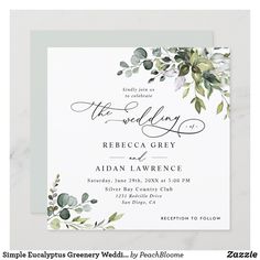 an elegant wedding card with eucalyptus leaves and greenery on the front, in white