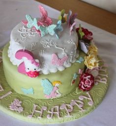 a birthday cake decorated with flowers and butterflies