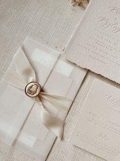 the wedding stationery is laid out on top of each other