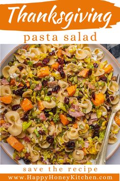 a white plate topped with pasta salad next to a fork and orange sign that reads thanksgiving pasta salad save the recipe