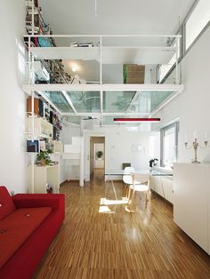 a living room with hard wood floors and white walls