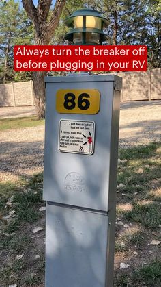 a parking meter sitting on the side of a road next to a street sign that says, always turn the breaker off before plugging in your rv