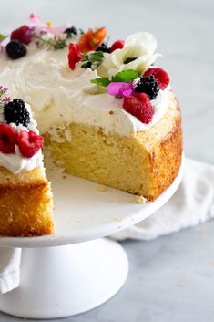 a cake with white frosting and fruit toppings is on a plate, ready to be eaten